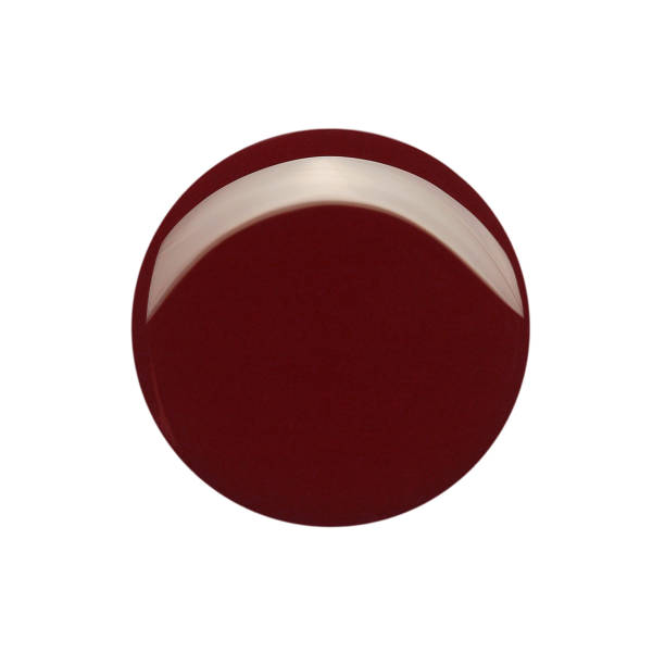 istock Blot of dark red circle shaped nail polish isolated on white 1321299563