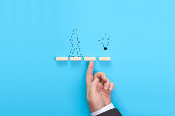istock Hand of a businessman supporting wooden step 1321299599
