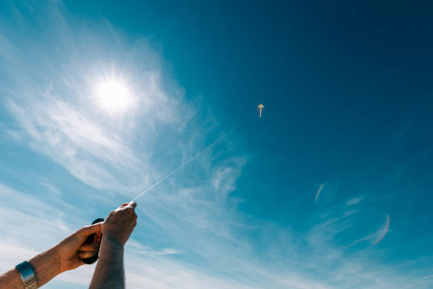 istock Senior man flying colorful rainbow kite at beach 1321299927
