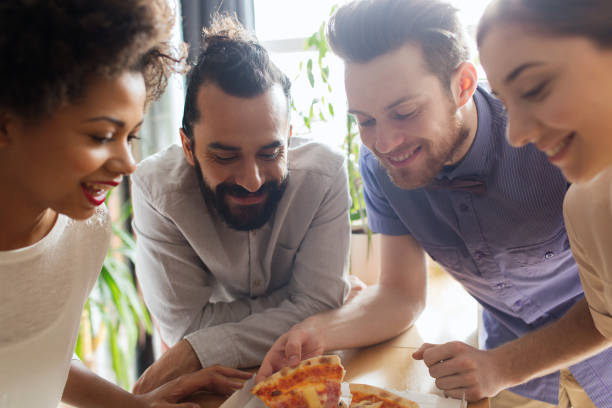 istock happy business team eating pizza in office 1321300884