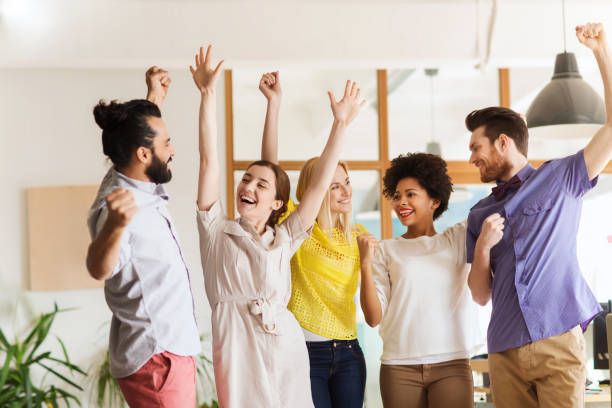 istock happy creative team celebrating victory in office 1321301000