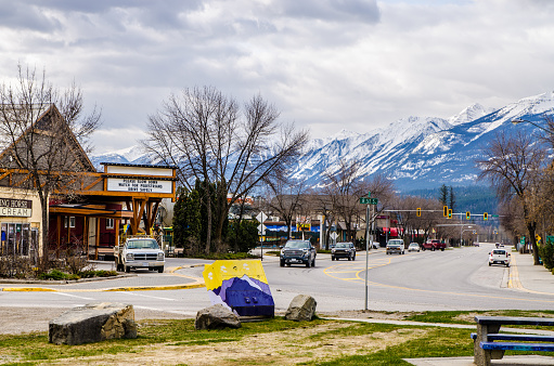 Main street in Golden, British Columbia, with Rocky mountains during day of springtime