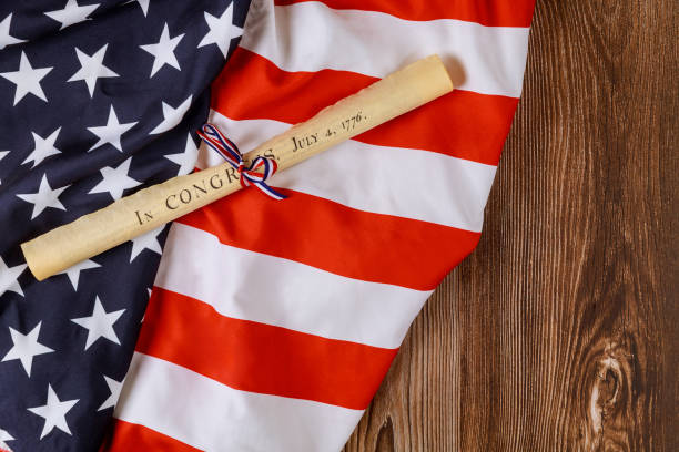istock American holiday. Declaration of Independence parchment roll document with US flag. 1321306659