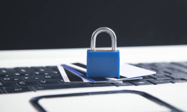 istock Padlock and credit cards on the computer keyboard. Credit card security 1321306781