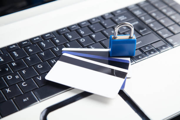istock Padlock and credit cards on the computer keyboard. Credit card security 1321306796