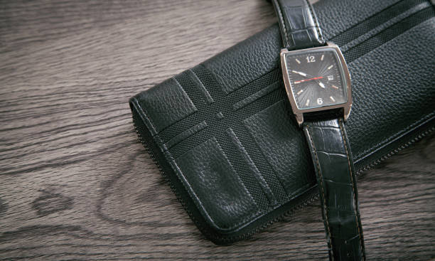 istock Black wristwatch and wallet on the desk. 1321306953