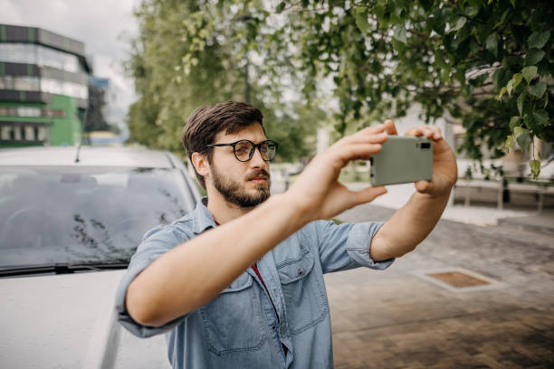 istock Young man taking a photo with smart phone 1321307102