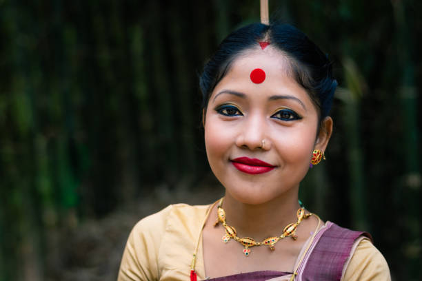 girl smiling face isolated dressed in traditional wearing on festival with blurred background girl smiling face isolated dressed in traditional wearing on festival with blurred background image is taken on the occasion of bihu at assam india. assam india stock pictures, royalty-free photos & images
