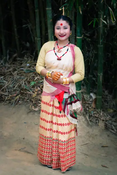 girl smiling face isolated dressed in traditional wearing on festival with blurred background image is taken on the occasion of bihu at assam india.