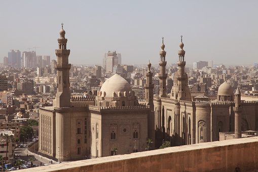 Exterior view of Mosque-Madrassa of Sultan Hassan with crowded cityscape, Cairo, Egypt.