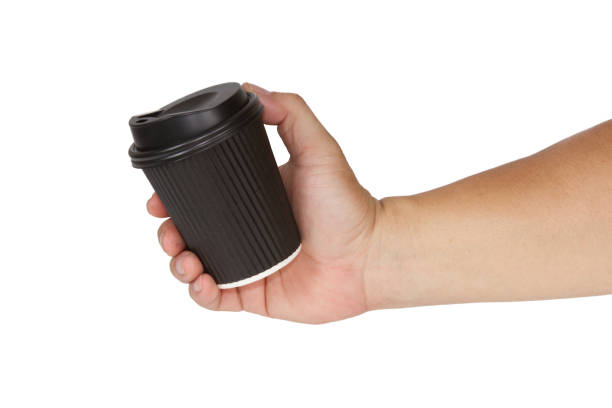 istock Hand holding Dark Brown Disposable Paper Coffee Cups isolated on white background. 1321309150