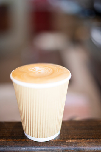 Aromatic coffee in takeaway paper cup and lid on white background