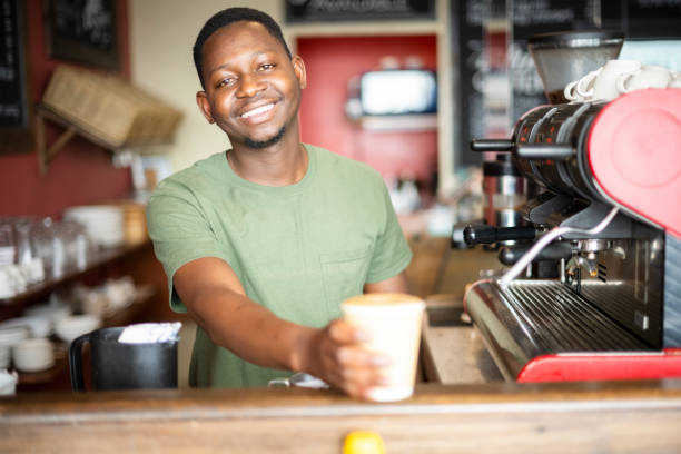 istock African barista smiling to camera with fresh coffee 1321311360