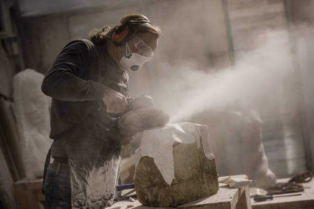 istock Stonemason cutting a stone with circular saw 1321311557