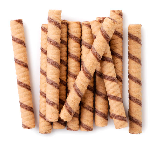 istock Striped wafer rolls with chocolate close-up on a white. Top view 1321312416