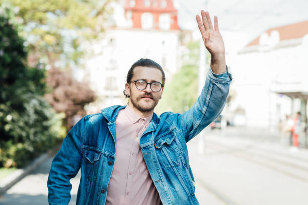 istock Young man catching a taxi 1321312837