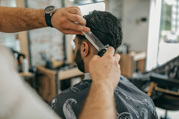 istock Young man getting haircut at barber shop 1321313053