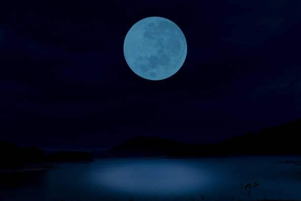 istock Full moon on sky over lake at night. 1321314766