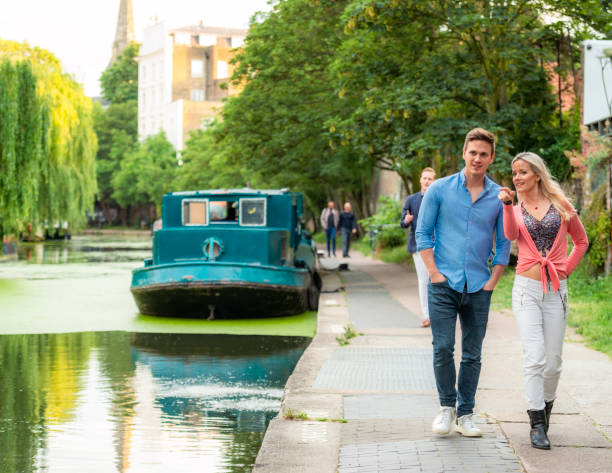 Visiting Regent's Canal in London A couple enjoying a visit to Regent's Canal in London. regents canal stock pictures, royalty-free photos & images