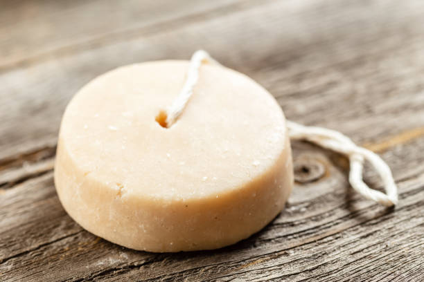 Shampoo bar, natural herbal soap or laundry soap on wooden background. Sustainable eco friendly product. Zero waste bathroom.