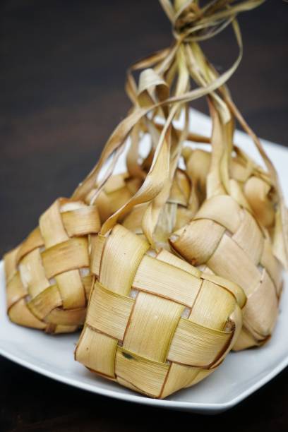 istock Selective focus of Rice Dumpling on white plate. Also known as 'Ketupat' in Malay. Made from young coconut leaves 1321317587