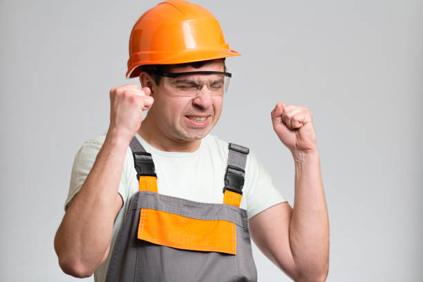 istock funny young disgruntled foreman in hysterics on gray isolated background, comic emotions on his face 1321317674