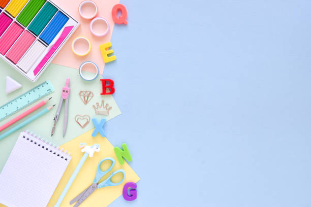 istock Top view of an empty office desk with an empty space on a pastel background. Back to school. Flat lay 1321318756