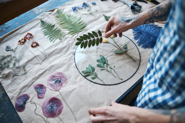istock Young man herbalist making herbarium at home 1321319429
