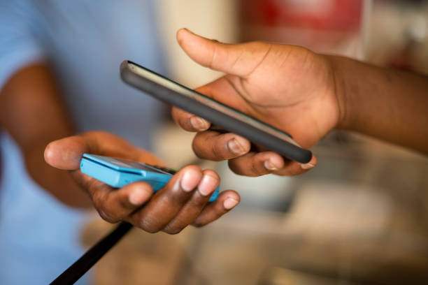 istock Close up hands holding smart phone contactless payment 1321320159