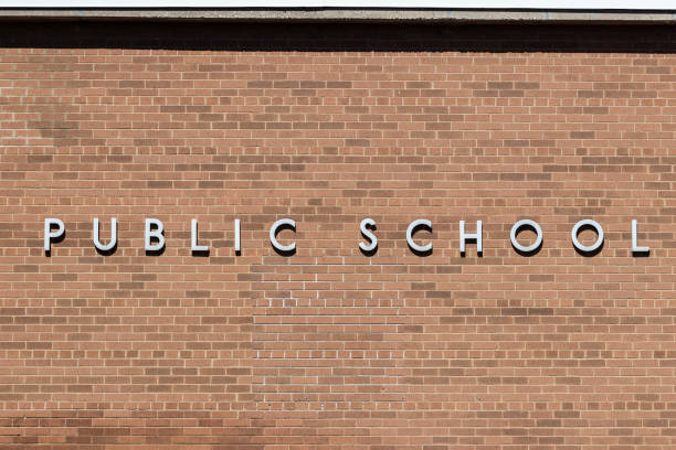 istock PUBLIC SCHOOL in stainless steel text against a brick background. 1321320713