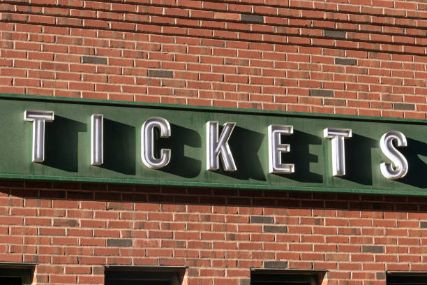 istock Ticket Window Sign in white text, with a green and brick background. 1321320864