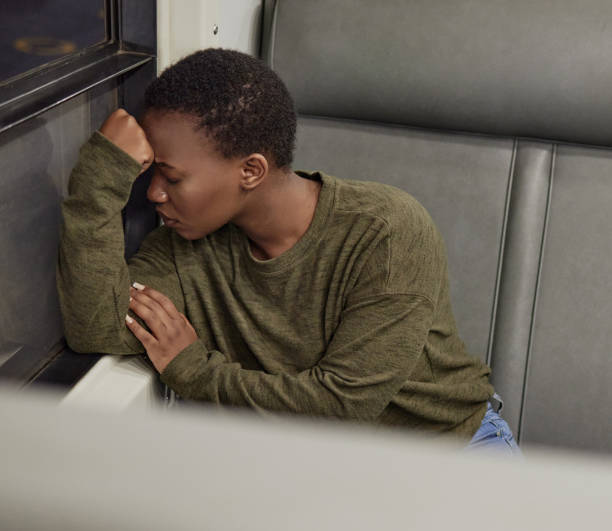 istock High angle shot of a young woman looking depressed while travelling by train 1321321864