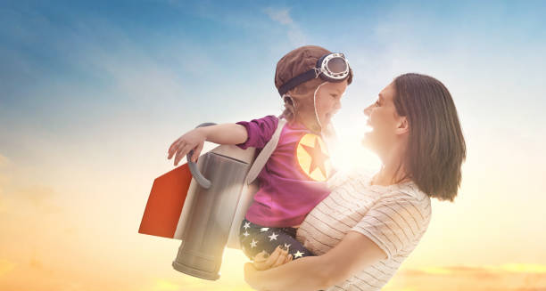 istock mother and child in astronaut costume 1321322521