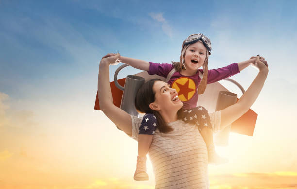 istock mother and child in astronaut costume 1321322522