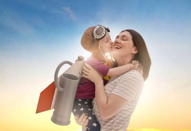 istock mother and child in astronaut costume 1321322571