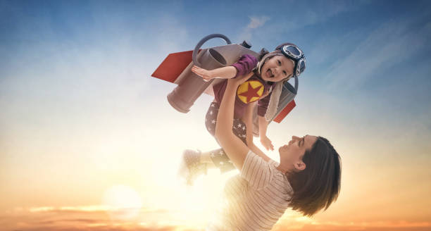 istock mother and child in astronaut costume 1321322689