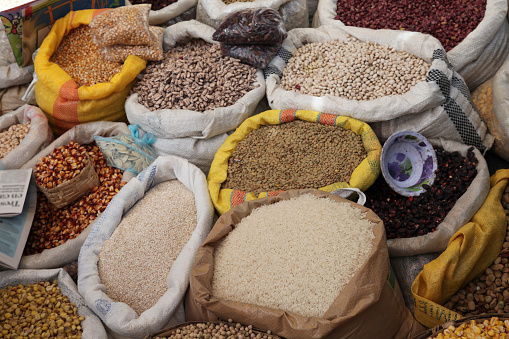Elevated view of sacks of cereals and pulses at market stall, Otavalo, Ecuador, South America.