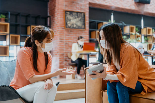 istock Young businesswomen with protective face mask working in co-working space 1321323638