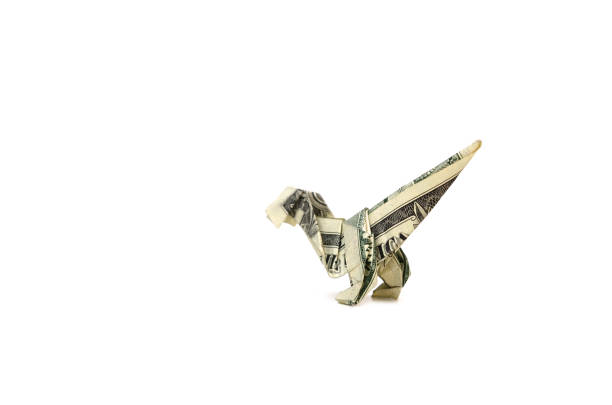 istock A dollar velociraptor Dinosaur origami on white 1321324213