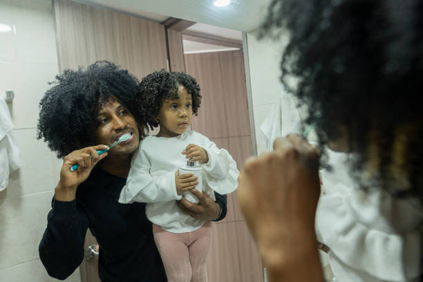 istock Young black father with his daughter brushing their teeth in the bathroom while enjoying his company during the pandemic 1321326624