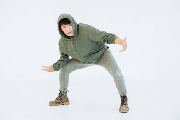 istock A man is performing a graceful dance in a white studio, performer masculine is a performance dancer, sportswear movement posing. 1321327859