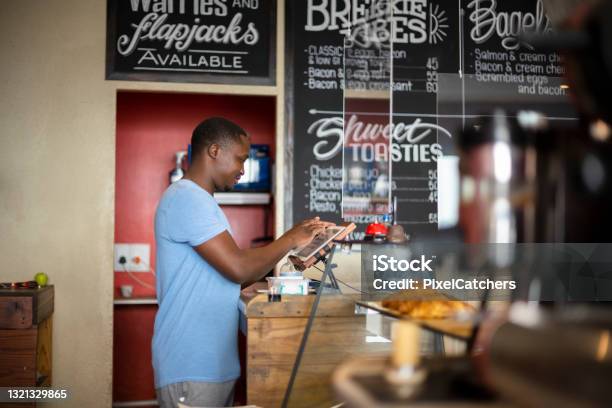 Cafe Barista Using Pos System For Customers Order Stock Photo - Download Image Now - Point Of Sale, Order, Restaurant