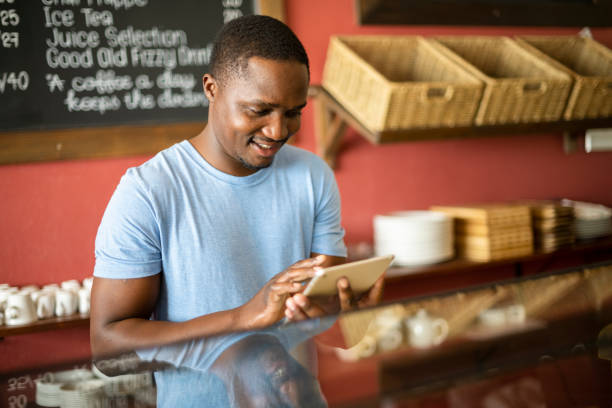 istock Happy cafe manager using digital tablet to take an order 1321330029