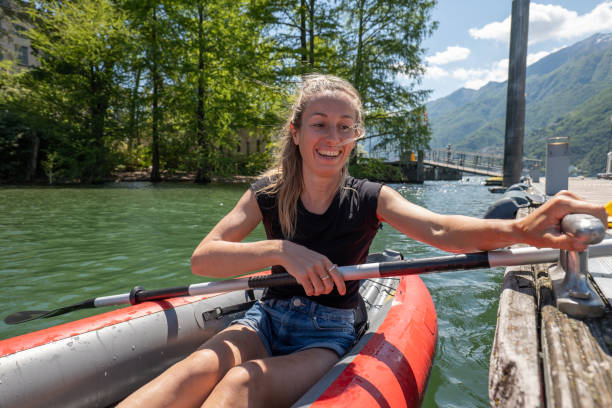 istock Young woman in red canoe getting on pier 1321331270