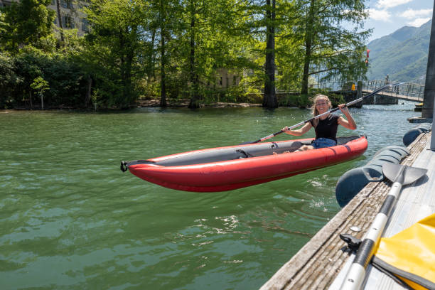 istock Young woman in red canoe getting on pier 1321331493