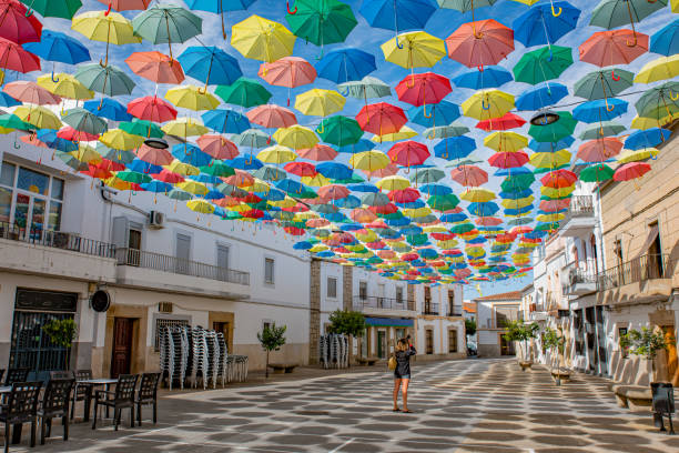 paraguas flotando en el cielo con mucho color en águeda, portugal - umbrella decoration fotografías e imágenes de stock