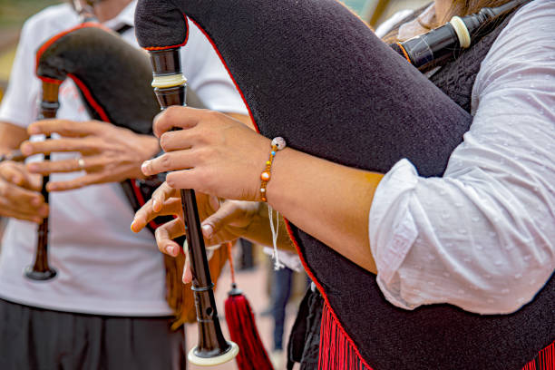 A bagpiper in the highlands of Scotland wearing a kilt with copy-space.