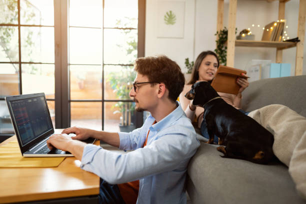 istock Side view of young couple using technology for tracking and trading stocks 1321334166