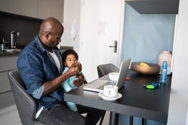 istock Father working at home and feeding baby son 1321335382
