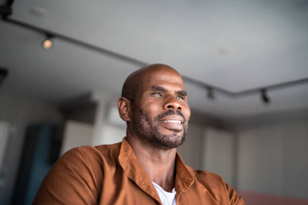 istock Mature man contemplating at home 1321336546